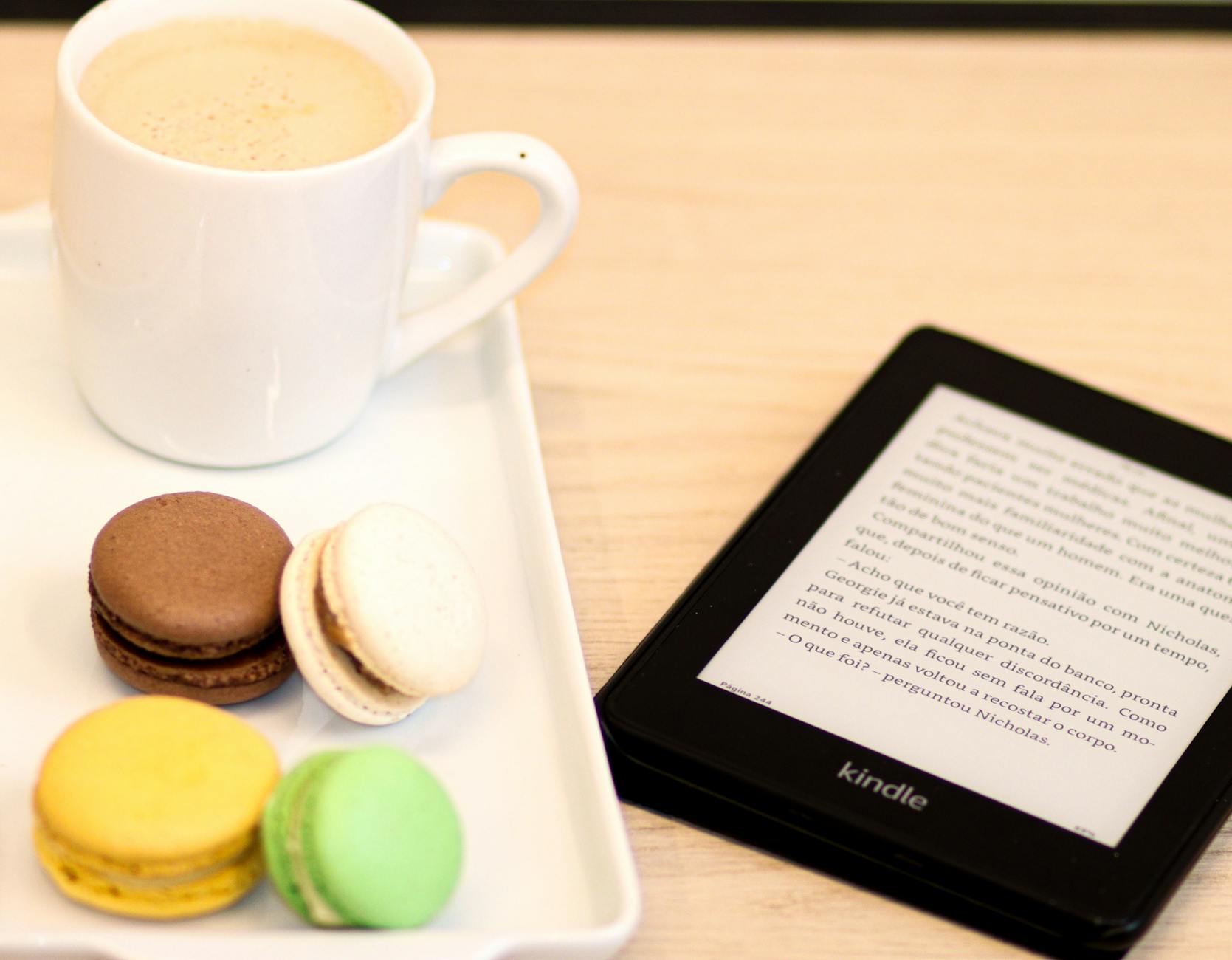 Macarons, EReader and Cup with Beverage