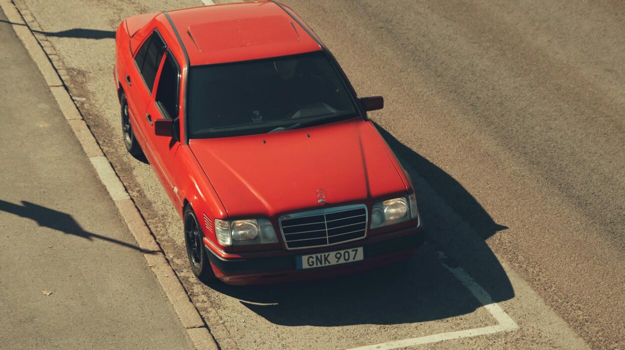 A red car parked on the side of the road