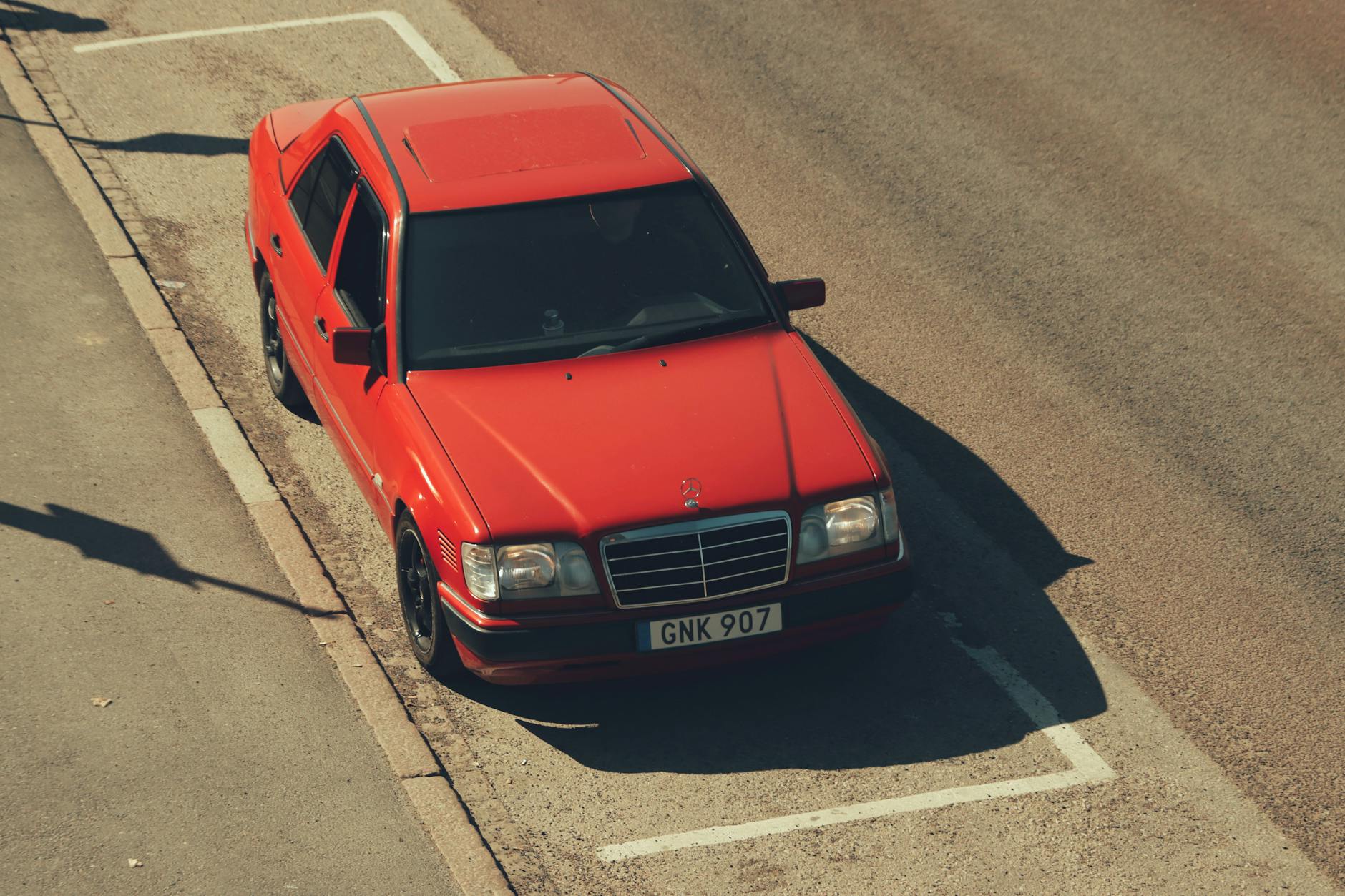 A red car parked on the side of the road