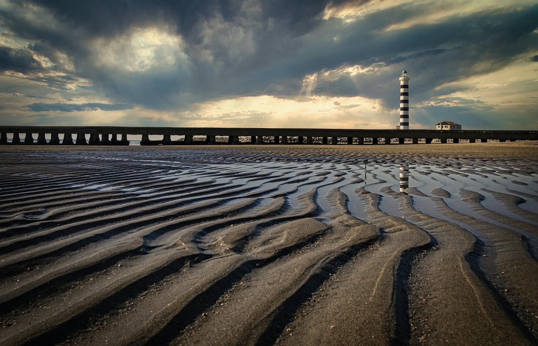 View of a Beach, Pier and Lighthouse in Lido di Jesolo, Italy