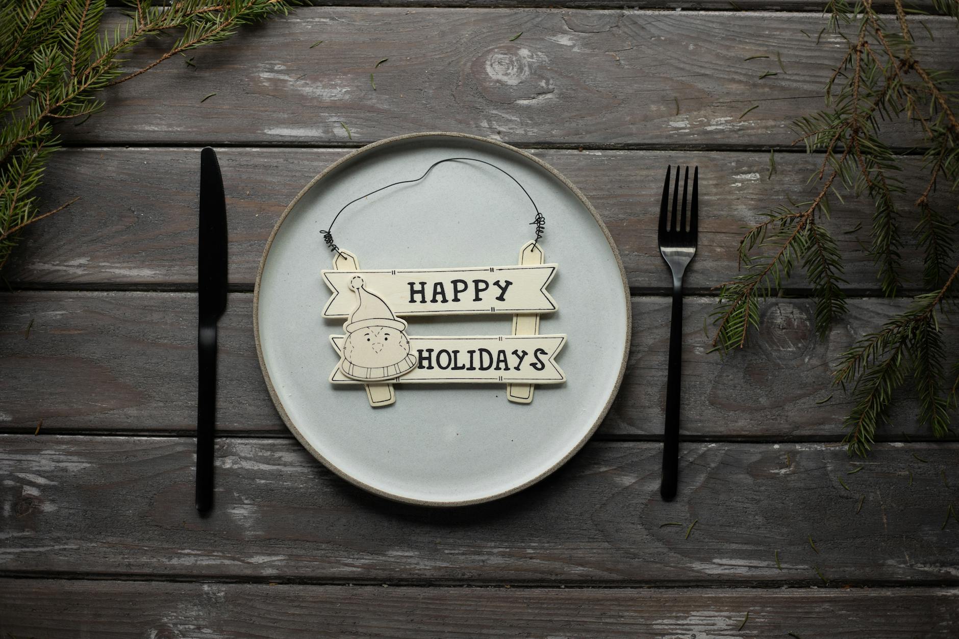 Served table with Happy Holidays inscription on plate