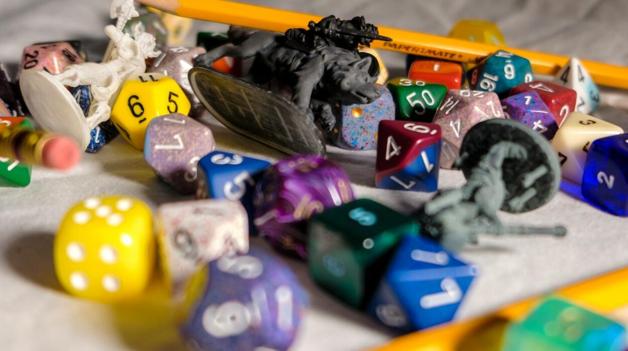 High angle of color dices in different shapes scattered on table with small toy animals and pencils during game